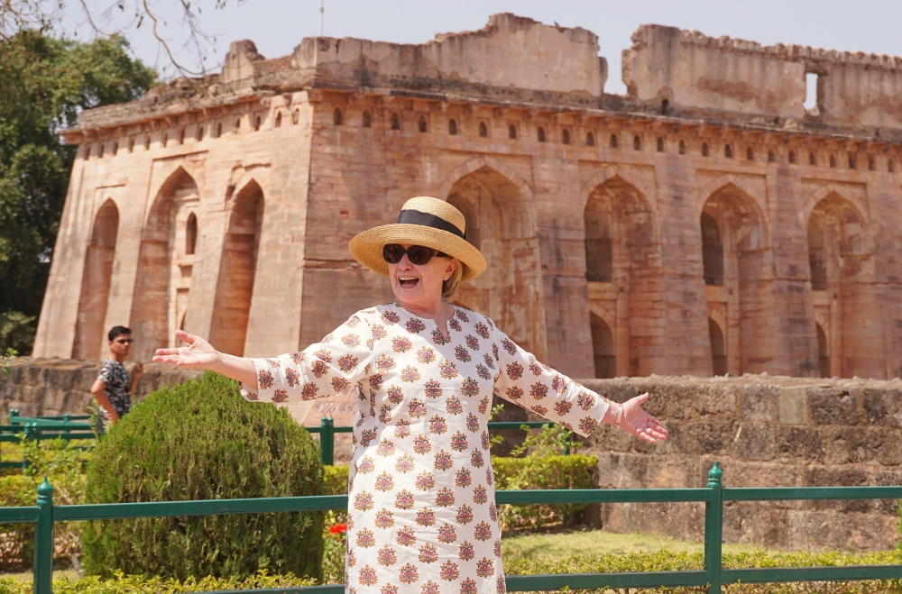 Former US politician Hillary Clinton gestures outside the remains of the Hindola Mahal monument, part of an abandoned royal palace complex, while on a personal trip to the ancient city of Mandu in India's Madhya Pradesh state on March 12, 2018. / AFP
