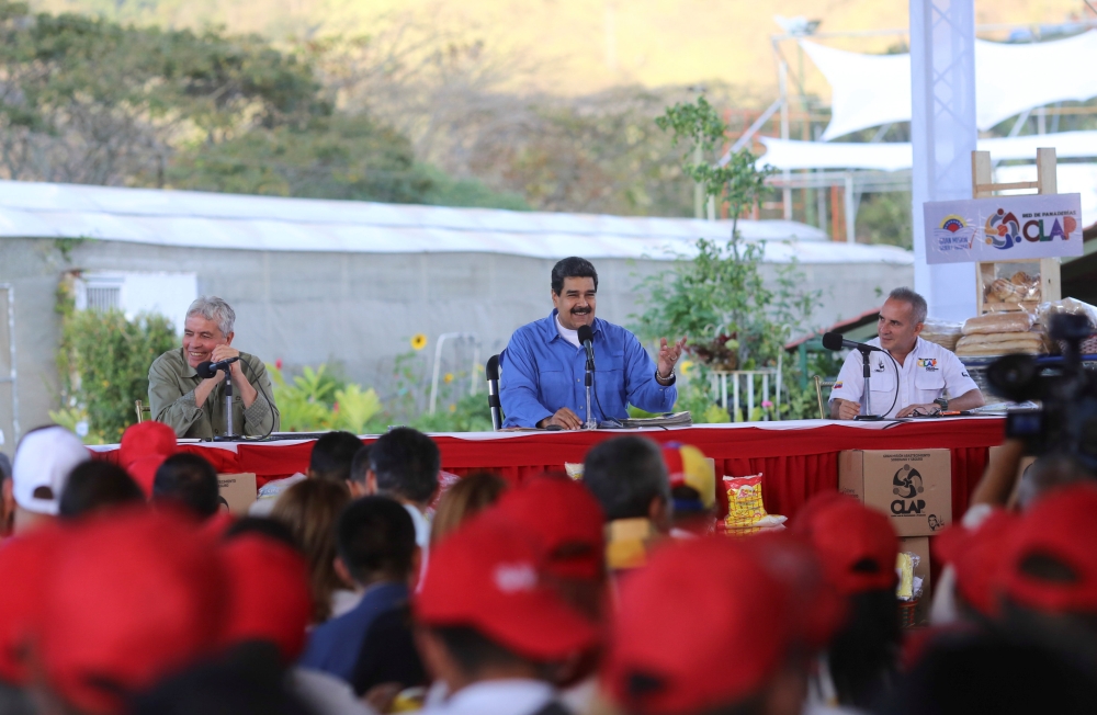 Venezuela's President Nicolas Maduro (C) speaks during an event regarding the CLAP (Local Committees of Supply and Production) program, a Venezuelan government handout of basic food supplies, in Caracas, Venezuela March 12, 2018. Miraflores Palace

