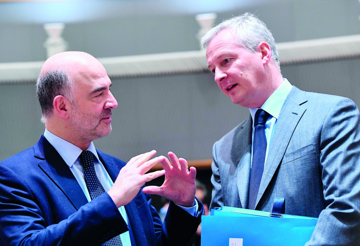 French Finance Minister Bruno Le Maire (R) and European Commissioner for Economic and Financial Affairs, Taxation and Customs Pierre Moscovici attend an Economic and Finance ministers meeting (ECOFIN) in Brussels on March 13, 2018. AFP / Emmanuel Dunand