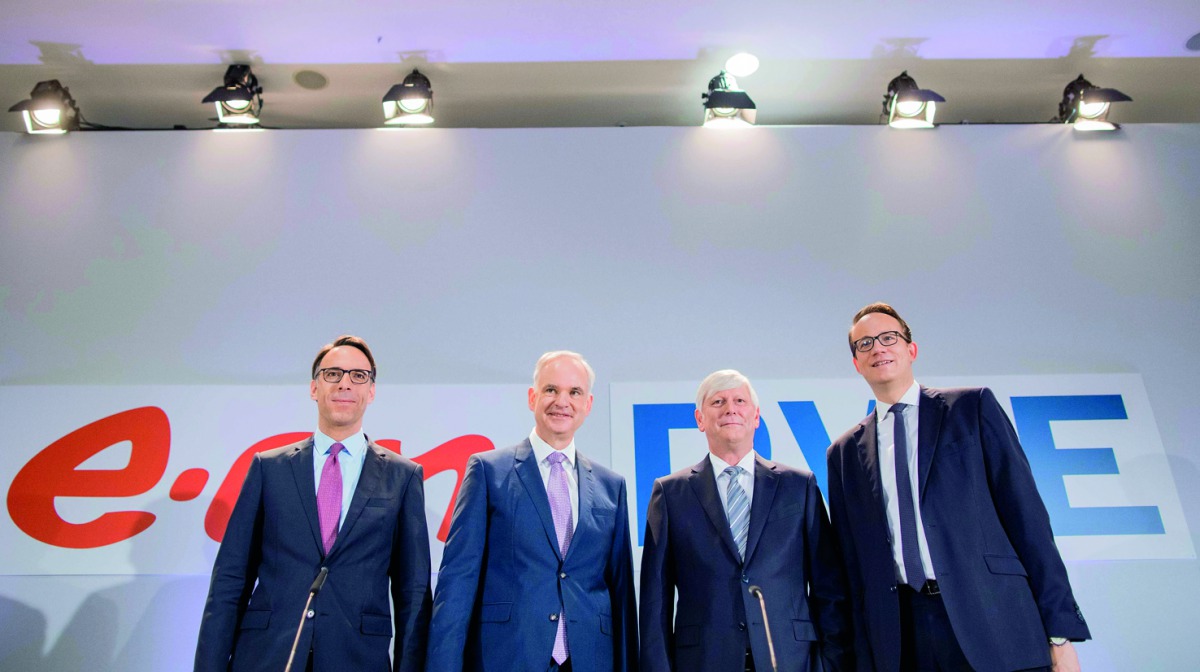 Rolf Martin Schmitz (2nd R), chairman of German energy supplier RWE, RWE CFO Markus Krebber (R), Johannes Teyssen (2nd L), CEO of German utility company EON, and EON CFO Mark Spieker (L) pose at the beginning of a joint press conference on March 13, 2018 