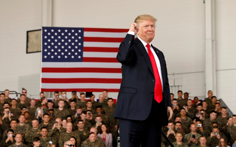 FILE PHOTO: US President Donald Trump pumps his fist after speaking at Marine Corps Air Station Miramar in San Diego, California, U.S. March 13, 2018. Reuters/Kevin Lamarque/File Photo