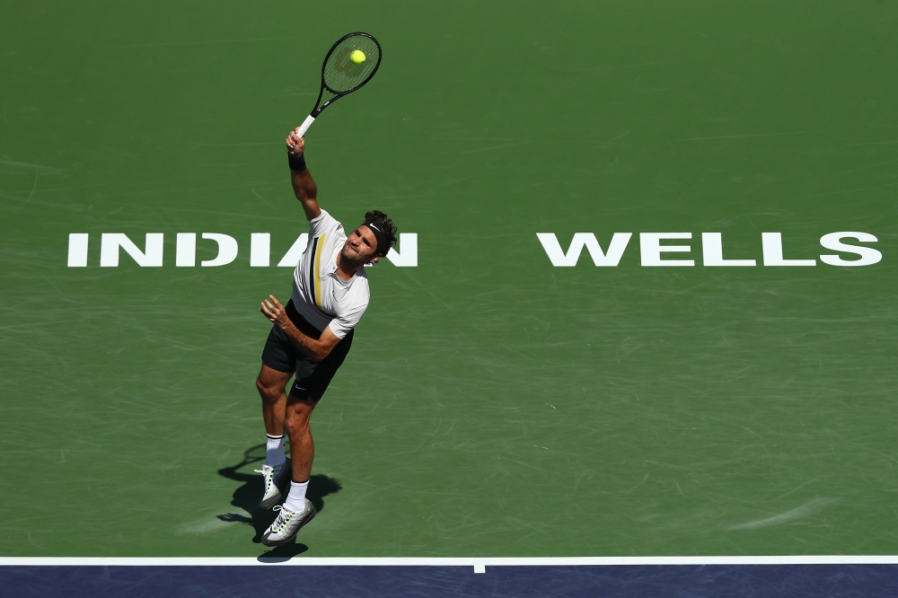 Roger Federer of Switzerland serves to Borna Coric of Croatia during the semifinal match at BNP Paribas Open - Day 13 on March 17, 2018, in Indian Wells, California. Joe Scarnici/Getty Images/AFP