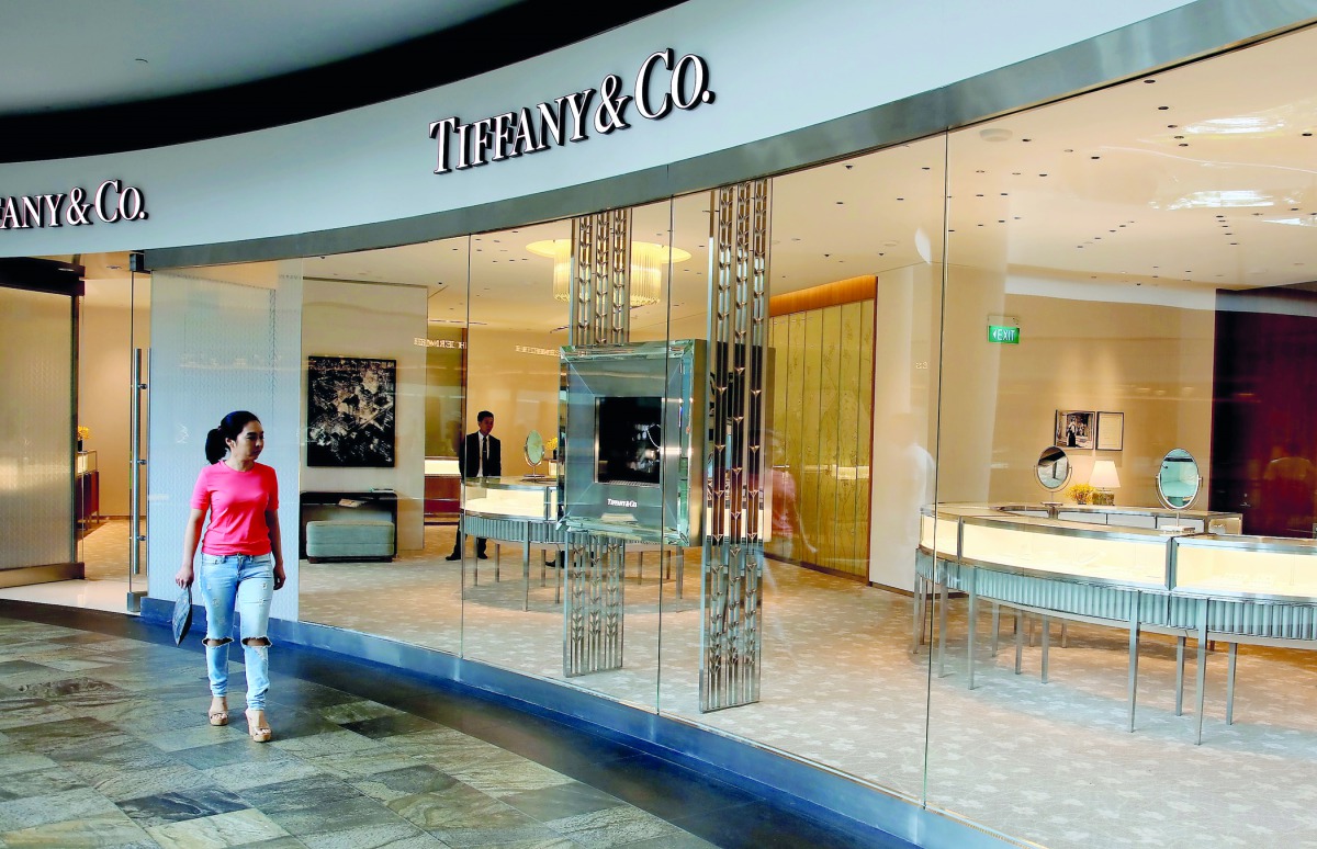 A woman walks past a Tiffany shop in Singapore May 19, 2017. Reuters/Thomas White