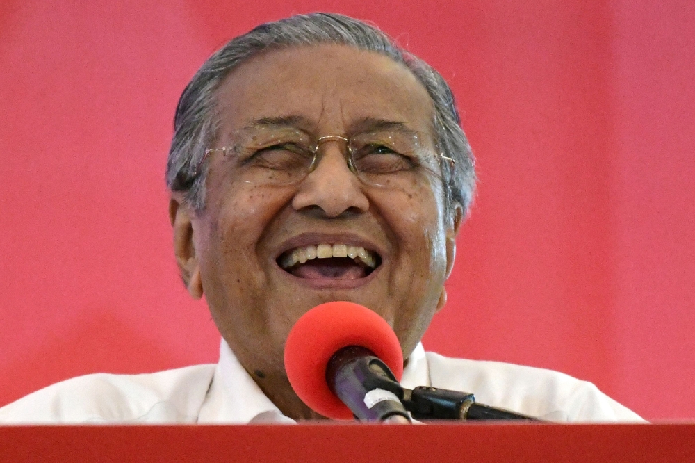 This file picture taken on March 8, 2018 shows former Malaysian prime minister and opposition's prime ministerial candidate Mahathir Mohamad smiling after launching the four-party coalition Pact of Hope (Pakatan Harapan) election manifesto in Shah Alam, o
