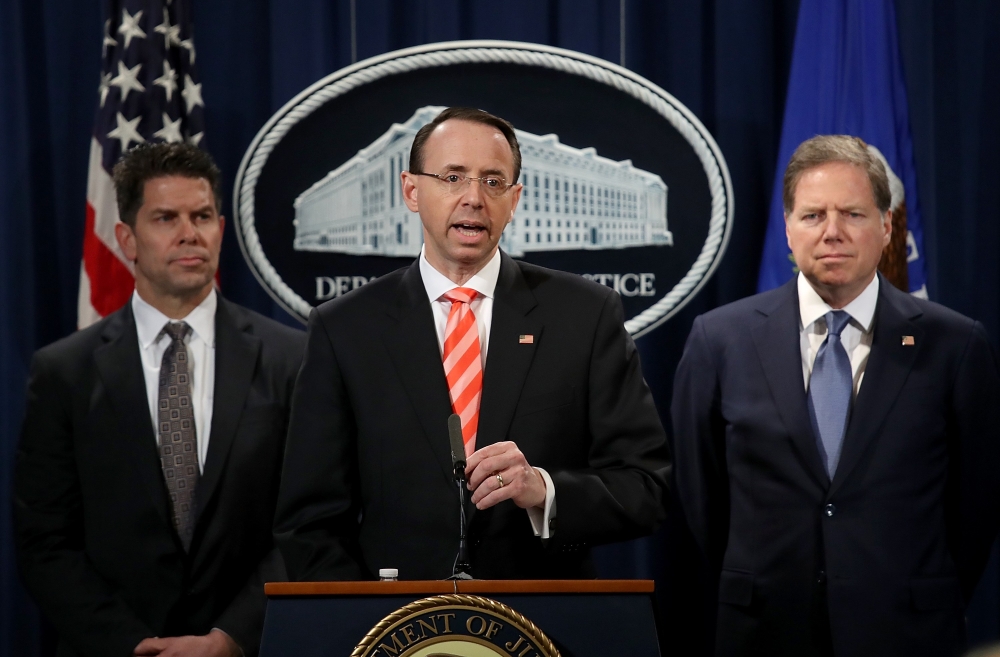 US Deputy Attorney General Rod Rosenstein speaks at a press conference at the Department of Justice March 23, 2018 in Washington, DC. Rosenstein and other law enforcement officials announced a major cyber law enforcement action against nine Iranians charg