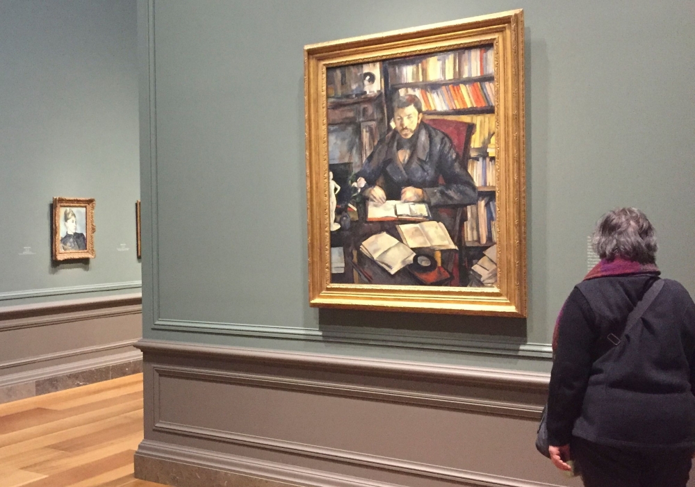 A woman looks at the painting Gustave Geffroy, 1895–1896, by Paul Cezanne, at the National Gallery of Art in Washington, DC on March 23, 2018. AFP / Olivia Hampton 