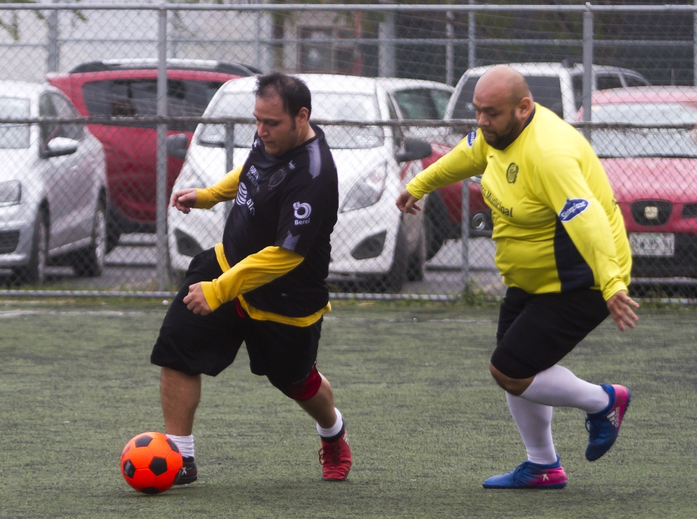 Two players vie for the ball during a soccer match between The Galaxy and Los Ombligones, as part of the 