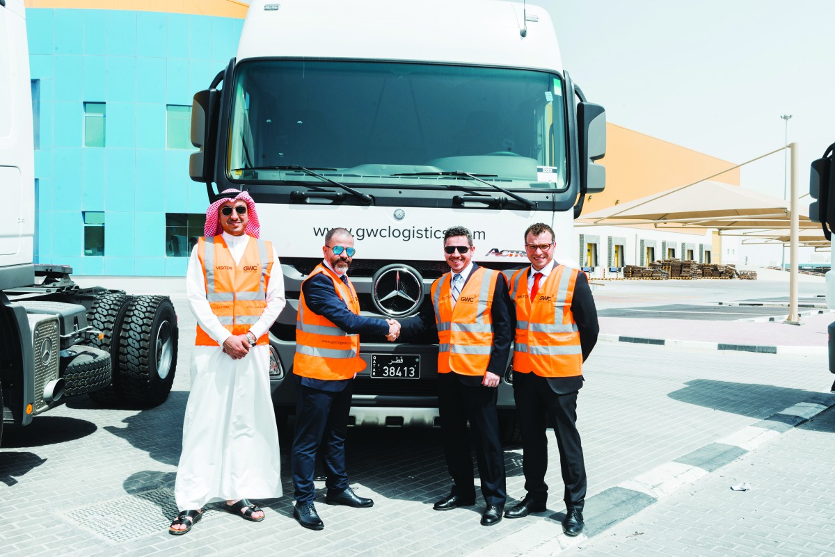 Top officials of NBK and GWC, standing next to Actros 2041 trucks in Logistics Village Qatar (LVQ), GWC’s 1M sqm logistics infrastructure serving Qatar’s logistical aspirations of the future.