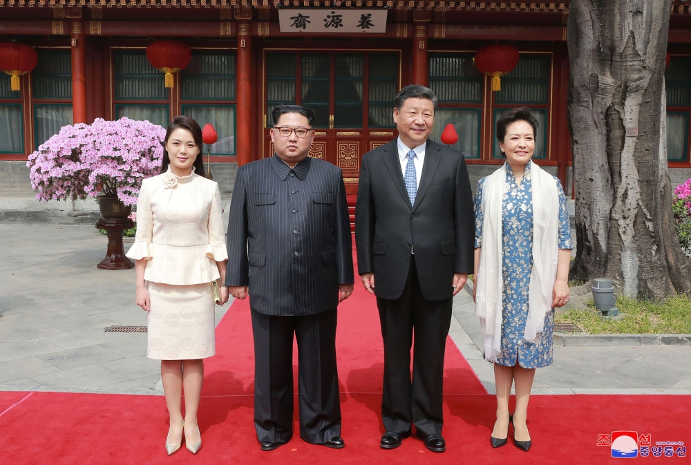 This picture from North Korea's official Korean Central News Agency (KCNA) taken on March 27, 2018 and released on March 28, 2018 shows China's President Xi Jinping (2nd R), his wife Peng Liyuan (R), North Korean leader Kim Jong Un (2nd L) and his wife Ri