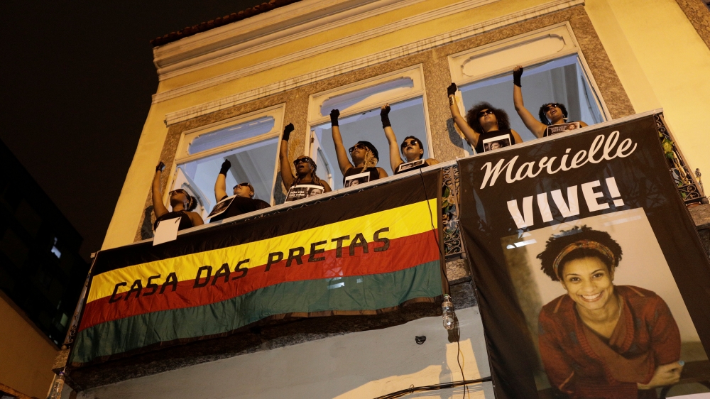 Demonstrators gesture as they take part in a protest against the shooting of Rio de Janeiro city councilor Marielle Franco, in front of the Casa das Pretas (Black women's House) in Rio de Janeiro, Brazil March 22, 2018. Reuters/Ricardo Moraes