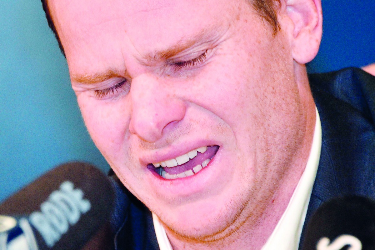Cricketer Steve Smith reacts at a press conference at the airport in Sydney on March 29, 2018, after returning from South Africa.  AFP / Peter Parks
