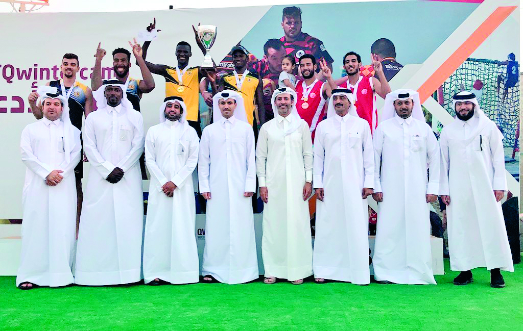 Podium winners of the inaugural Emir’s Beach Volleyball Cup pose for a photograph with Secretary-General of the Qatar Olympic Committee (QOC), Jassim Rashid Al Buenain and other officials during the presentation ceremony.  