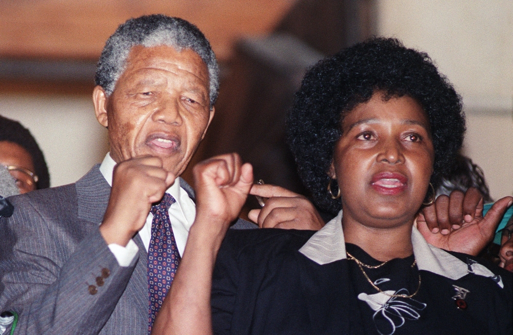 In this file photo taken on February 11, 1990, anti-apartheid leader and African National Congress (ANC) member Nelson Mandela and wife Winnie Madikizela-Mandela raise fists upon Mandela release from Victor Verster prison in Paarl.  AFP / Walter Dhaldhla