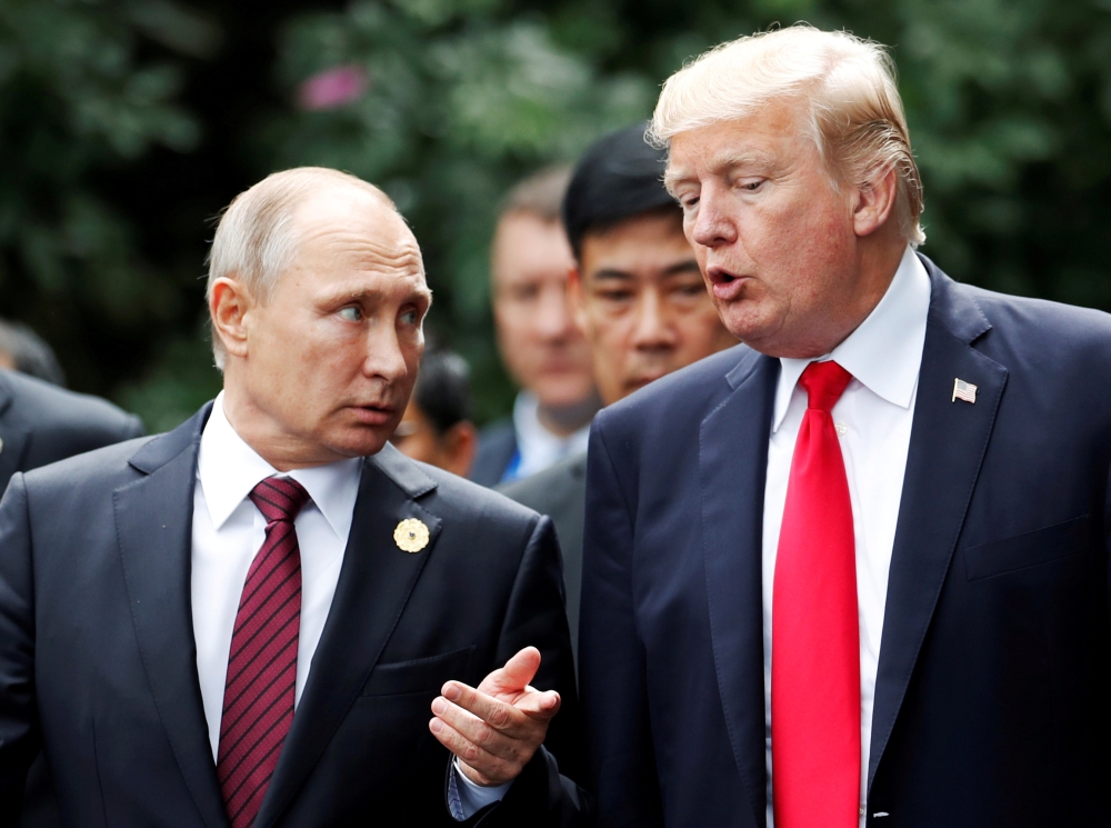 FILE PHOTO: U.S. President Donald Trump and Russia's President Vladimir Putin talk during the family photo session at the APEC Summit in Danang, Vietnam November 11, 2017. REUTERS/Jorge Silva/File Photo