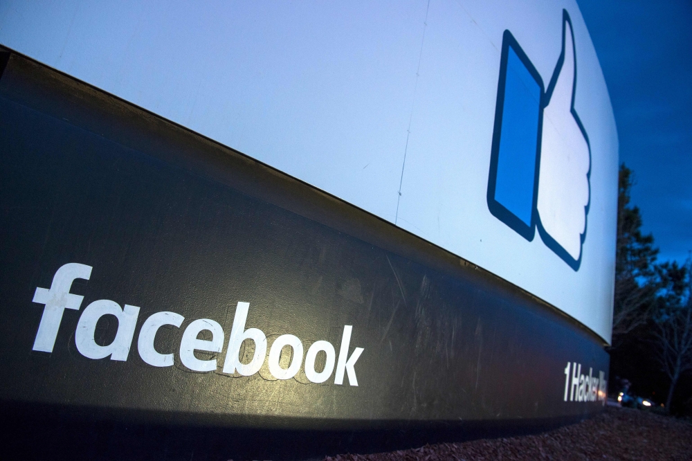 (FILES) In this file photo taken on March 21, 2018 a lit sign is seen at the entrance to Facebook's corporate headquarters location in Menlo Park, California. AFP / JOSH EDELSON