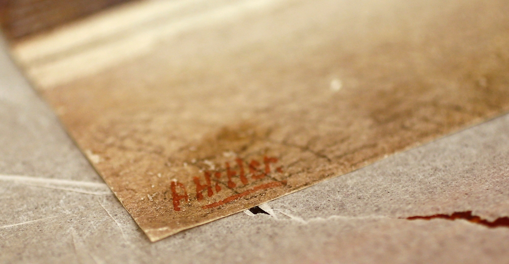 The signature of former German dictator Adolf Hitler is seen on a painting of the old registry office in Munich, at Weidler auction house in Nuremberg November 18, 2014. Reuters/Kai Pfaffenbach