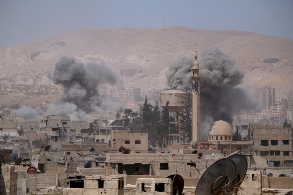 Smokes rise after Assad Regime forces carried out airstrikes in Eastern Ghouta's Douma town in Damascus, Syria on April 07, 2018.  Halil el-Abdullah - Anadolu
