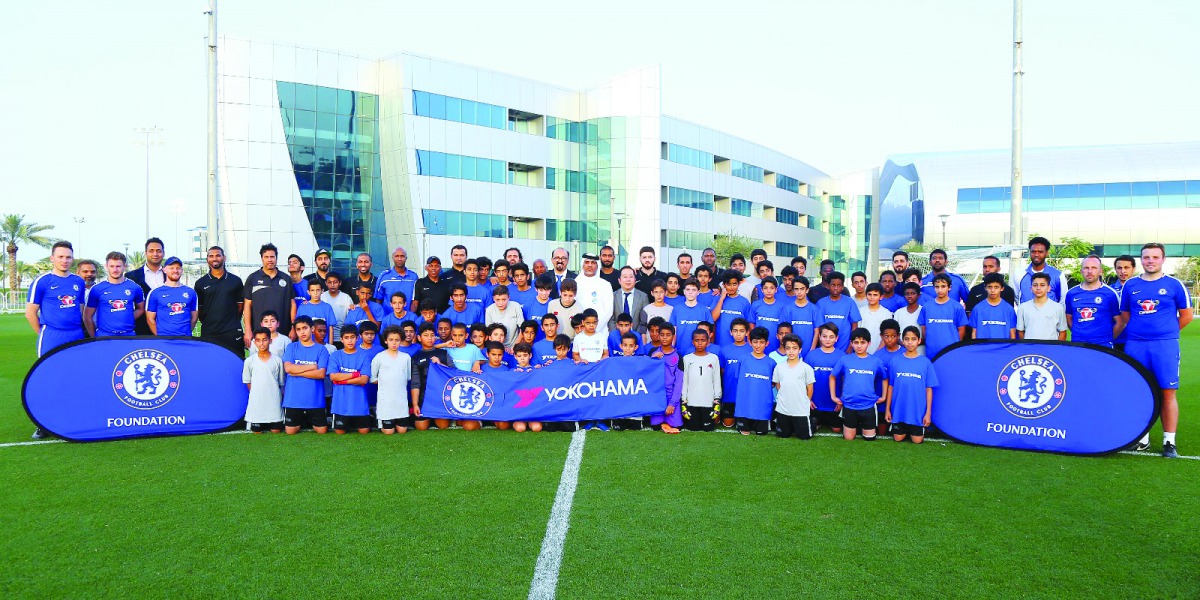 Officials from Qatar Football Association (QFA), Chelsea Foundation and Yokohama Tyres pose for a photograph with participants of the coaching clinic conducted by the QFA Football Development Department and Chelsea Foundation.