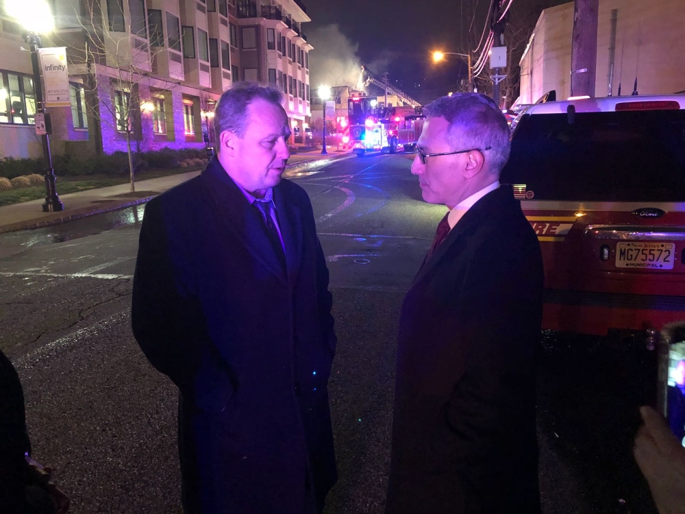 Turkish Consulate General in New York Ertan Yalcin (R) gets information from Michael McPartland (L), the Mayor of Edgewater, as firefighters try to extinguish the fire broke out at a Turkish restaurant in New Jersey, United States on April 9, 2018. (Vural