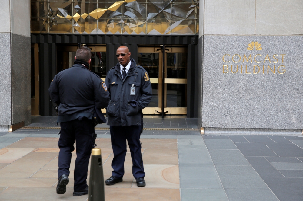 Police and security stand outside 30 Rockefeller Plaza, the location for the offices of US President Donald Trump's lawyer Michael Cohen which was raided by the F.B.I. today in the Manhattan borough of New York City, New York, U.S., April 9, 2018. REUTERS