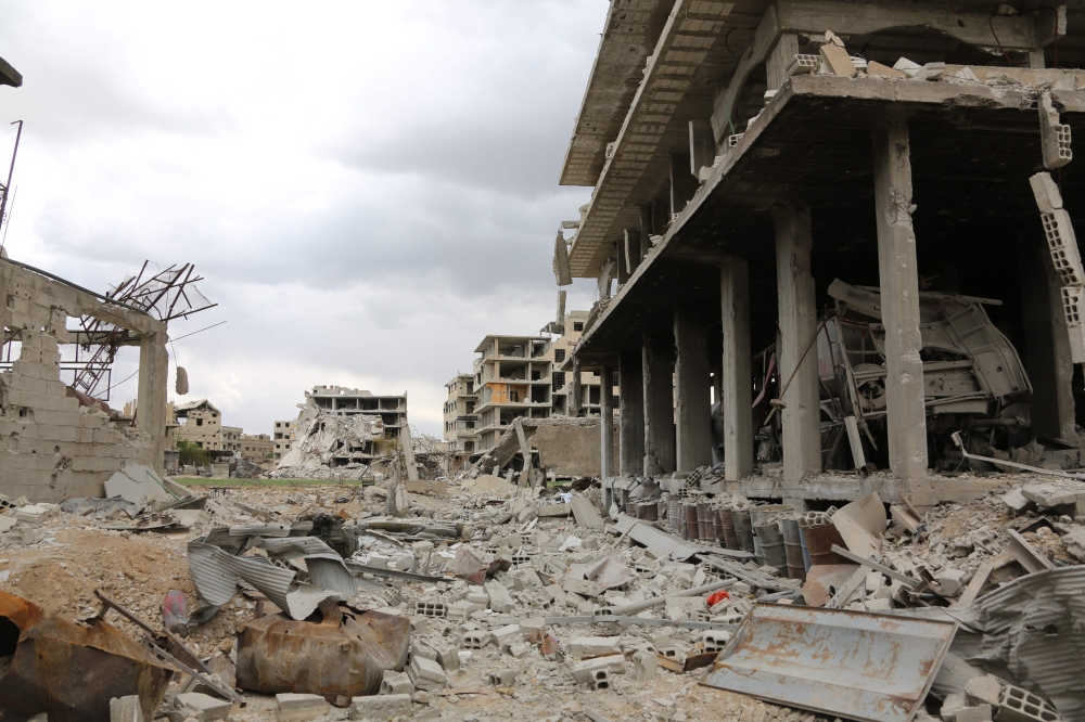 Destruction is seen in the former rebel-held town of Saqba in the Eastern Ghouta region on the outskirts of the Syrian capital Damascus on April 10, 2018. / AFP / STRINGER