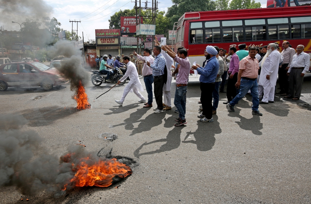 Activists of National Panther party burn tyres and shout slogans during a protest in support of various demands, including deportation of Rohingyas and Bangladeshi nationals from Jammu, and a CBI probe into the rape and murder of an eight-year-old girl in