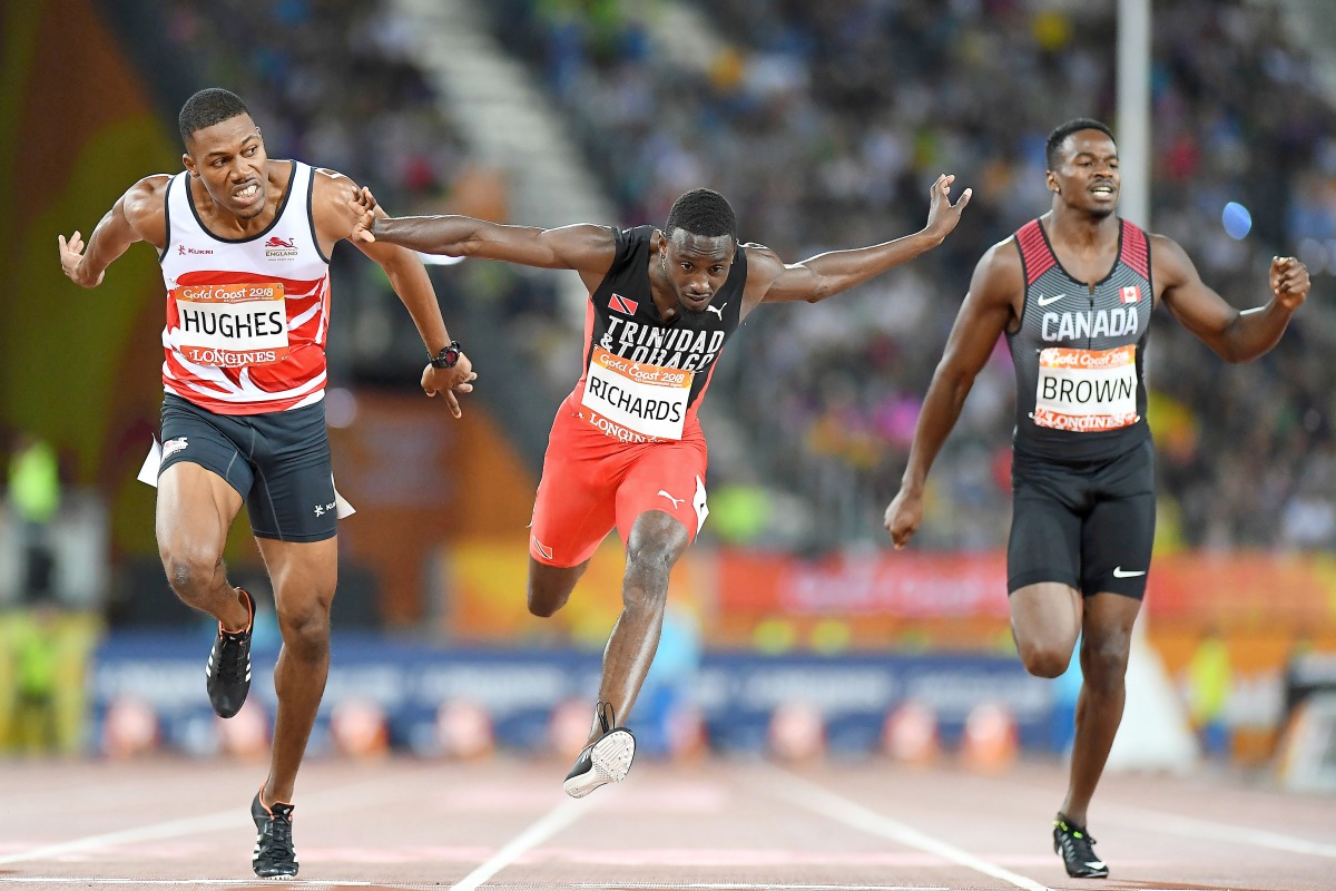 (From L) England’s Zharnel Hughes, Trinidad And Tobago’s Jereem Richards and Canada's Aaron Brown cross the finish line of the athletics men's 200m final during the 2018 Gold Coast Commonwealth Games at the Carrara Stadium on the Gold Coast on April 12, 2