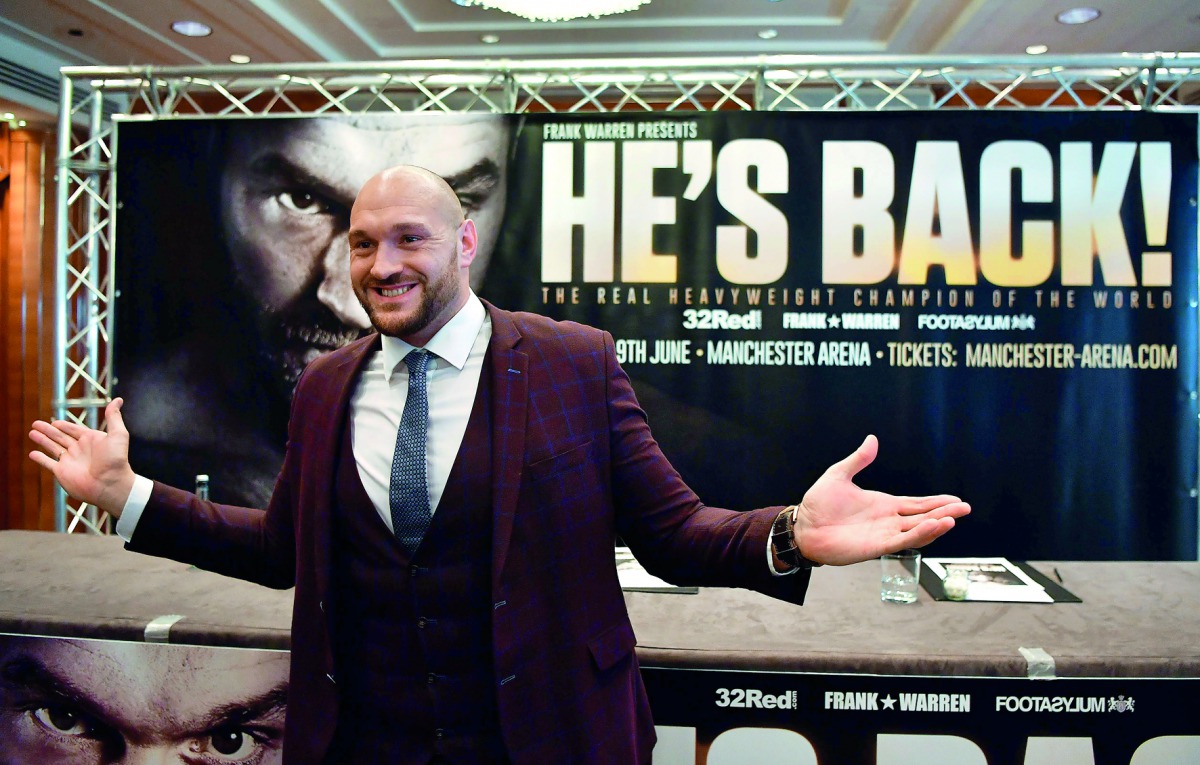 Former British heavyweight world boxing champion Tyson Fury gestures during a press conference to announce his comeback, in central London on April 12, 2018.  AFP / Ben Stansall