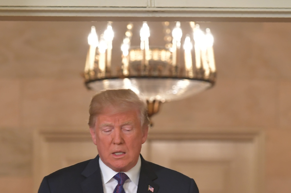 US President Donald Trump arrives to address the nation on the situation in Syria April 13, 2018 at the White House in Washington, DC. Trump said strikes on Syria are under way. AFP / Mandel Ngan 