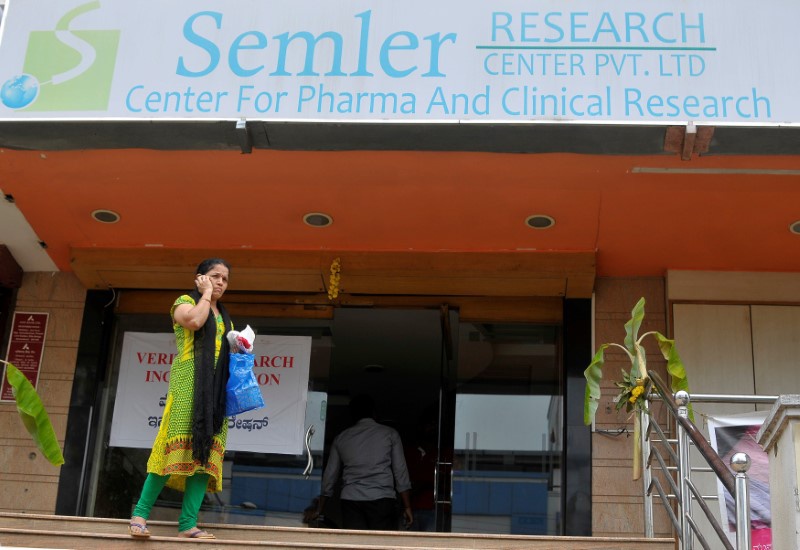 A woman talks on a mobile phone as she walks past the closed research facility of Semler Research Centre in Bengaluru, October 13, 2016. Reuters/Abhishek N Chinnappa