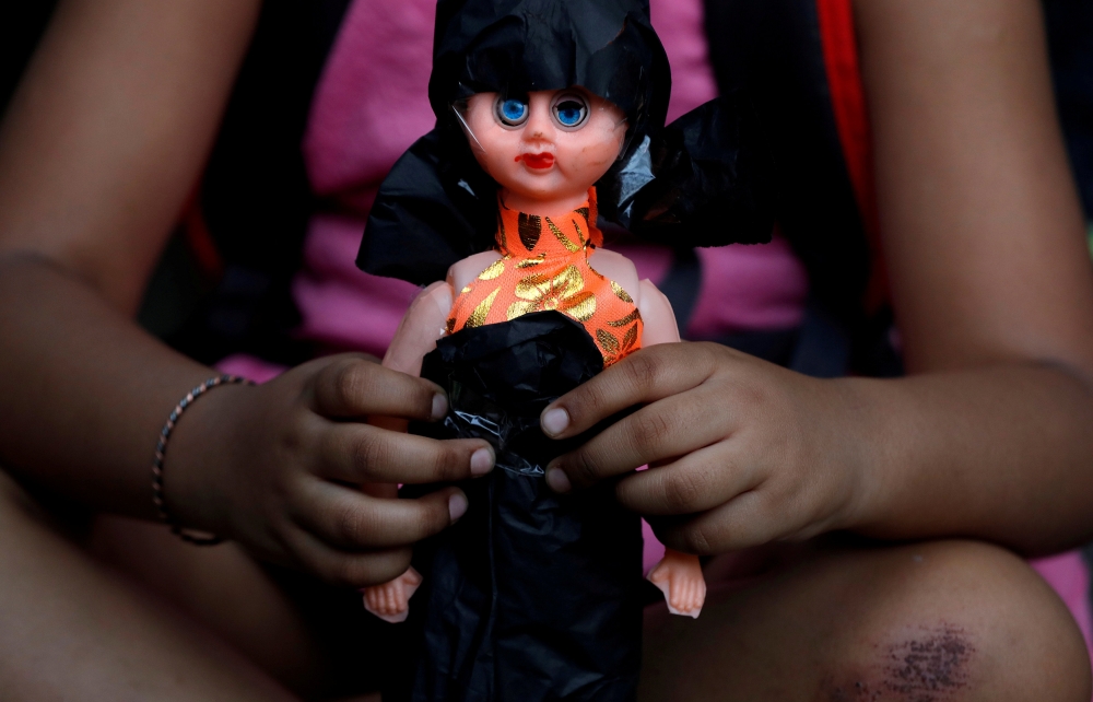 A child attends a protest against the rape of an eight-year-old girl, in Kathua, near Jammu and a teenager in Unnao, Uttar Pradesh state, in New Delhi, India April 15, 2018. REUTERS/Cathal McNaughton 