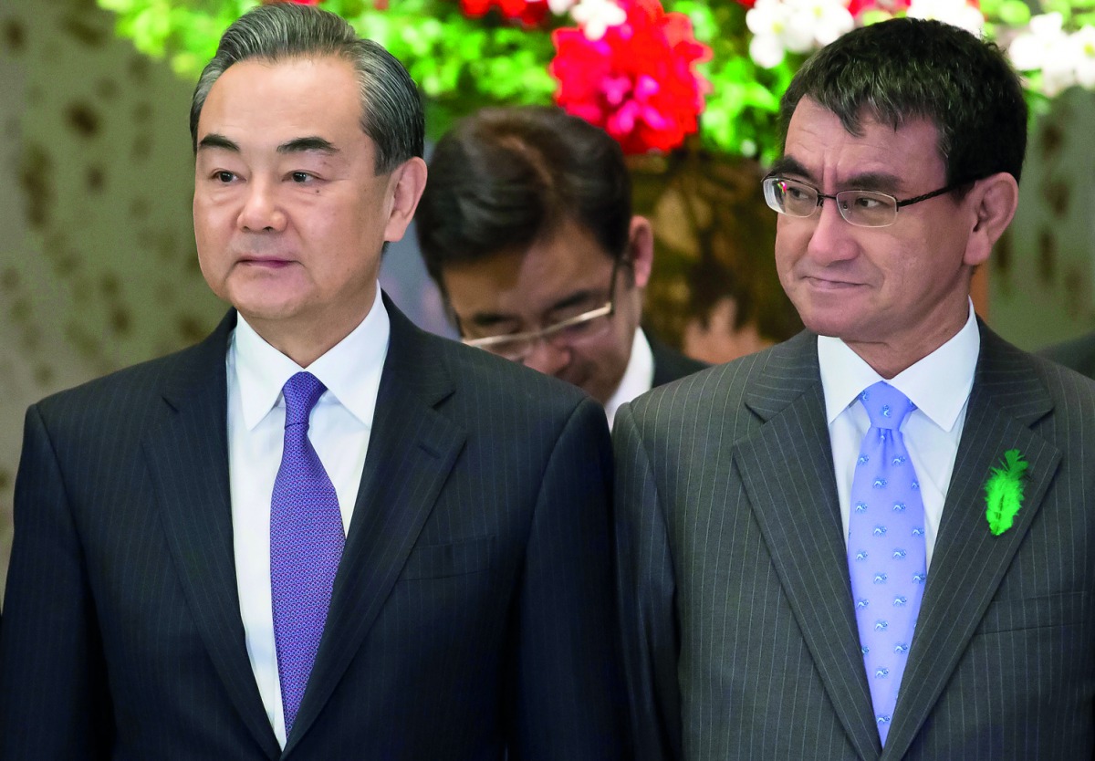 Wang Yi, China's foreign minister, and Taro Kono, Japan's foreign minister, pose during a photo session ahead of a high-level Japan-China economic dialogue in Tokyo, Japan, April 16, 2018. Tomohiro Ohsumi/Pool via Reuters