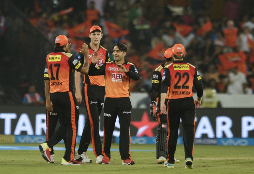 Sunrisers Hyderabad cricketer Rashid Khan (C) celebrates with teammates the wicket of Mumbai Indians Ben Cutting during the 2018 Indian Premier League (IPL) Twenty20 cricket match between Sunrisers Hyderabad and Mumbai Indians at the Rajiv Gandhi Internat