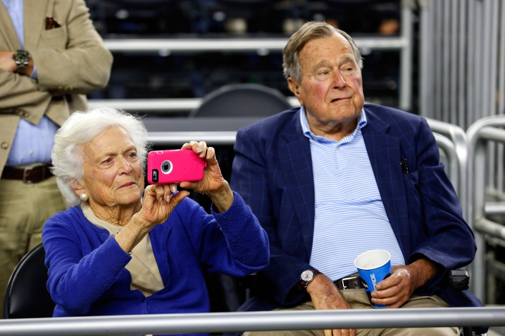 File photo of (L-R) Former First Lady Barbara Bush and former President George H.W. Bush looking on prior to the South Regional Final of the 2015 NCAA Men's Basketball Tournament between the Duke Blue Devils and the Gonzaga Bulldogs at NRG Stadium on Marc