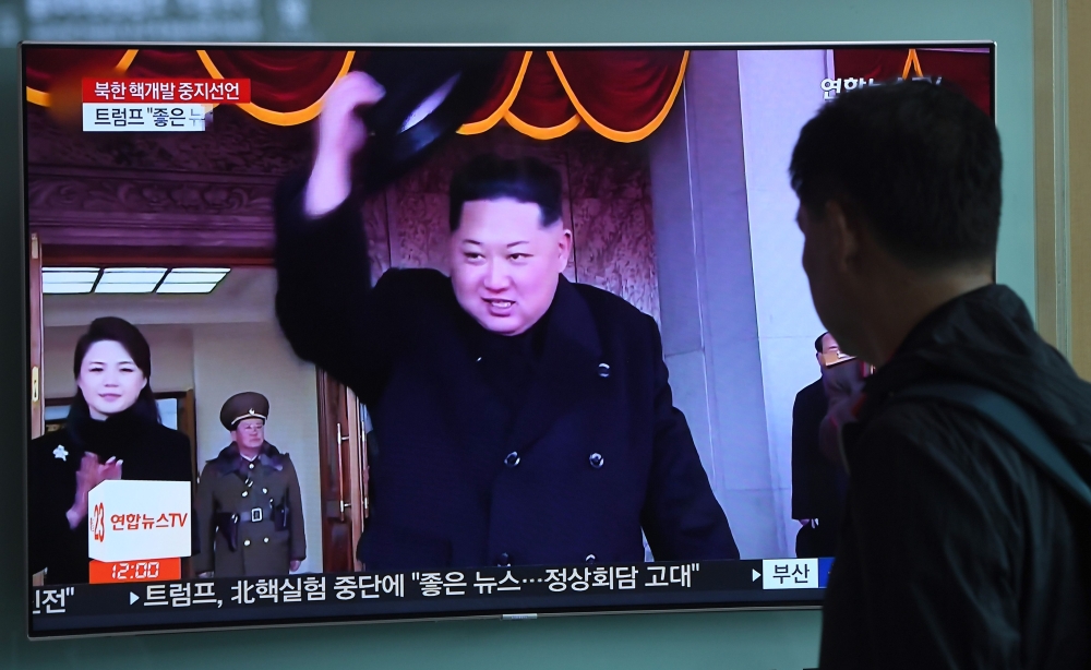 A man watches a television news showing a file footage of North Korean leader Kim Jong Un, at a railway station in Seoul on April 21, 2018. AFP / Jung Yeon-je