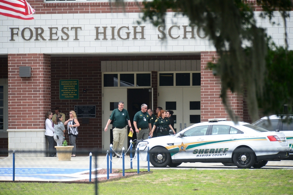 Marion County Police officers walk out Forest High School after a school shooting on April 20, 2018 in Ocala, Florida. It was reported that a former student shot a 17-year-old male student in the ankle The shooter, whose name has not yet been released, is