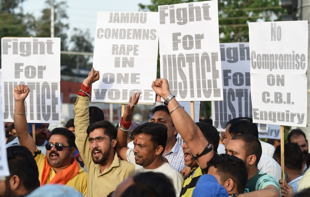 Indian supporters of Bharatiya Janata Party (BJP) leader Chaudhary Lal Singh, who resigned from the state cabinet over the Kathua rape and murder case of an eight-year-old girl, hold placards during a rally in support of a new probe led by the federal Cen