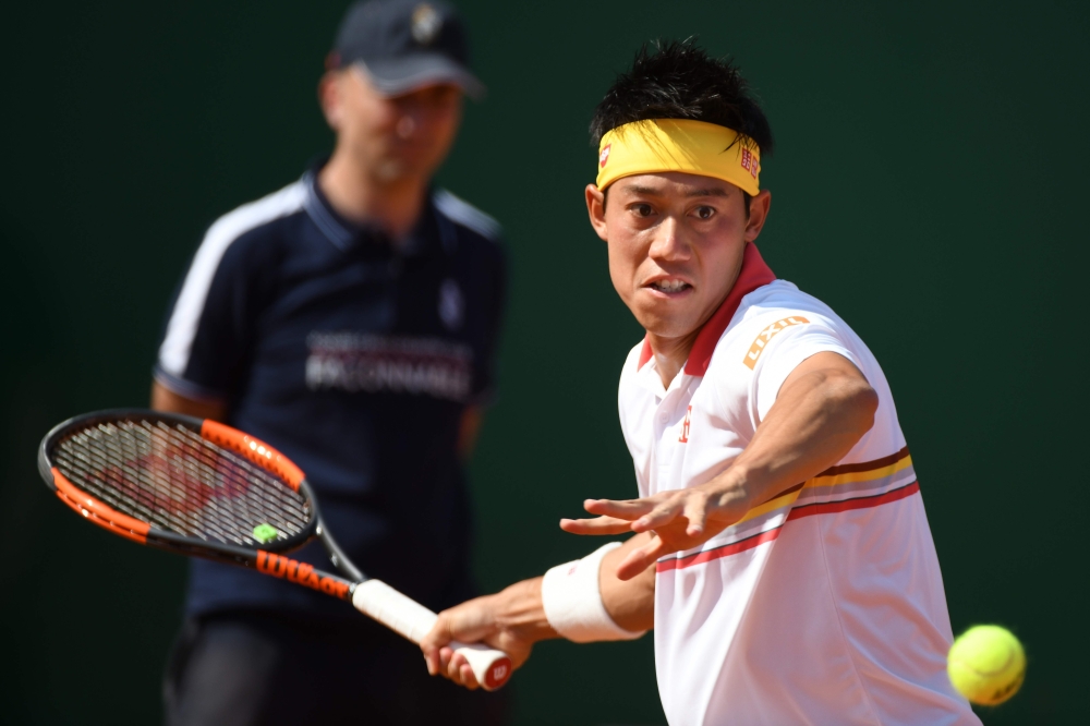 Japan's Kei Nishikori returns the ball to Germany's Alexander Zverev during their men's single semi-final tennis match at the Monte-Carlo ATP Masters Series tournament on April 21, 2018, in Monaco. AFP / YANN COATSALIOU