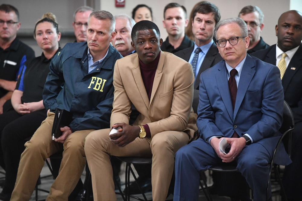 Waffle House patron James Shaw, Jr. (C) who stopped the shooting at a Waffle House where a gunman opened fire killing four and injuring two attends a press conference with FBI Special Agent In Charge, Matthew Espenshade (L) and Metro Nashville Mayor David