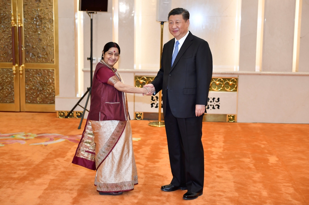 Indian Foreign Minister Sushma Swaraj shakes hands with Chinese President Xi jinping before a meeting at the Great Hall of the People in Beijing, China April 23, 2018. Naohiko Hatta/Pool via REUTERS