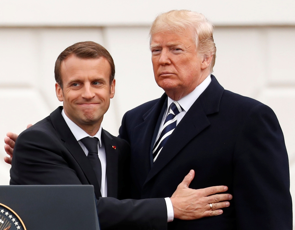 French President Emmanuel Macron (L) and U.S. President Donald Trump embrace during the official arrival ceremony for Macron on the South Lawn of the White House in Washington, U.S., April 24, 2018. Reuters/Jonathan Ernst