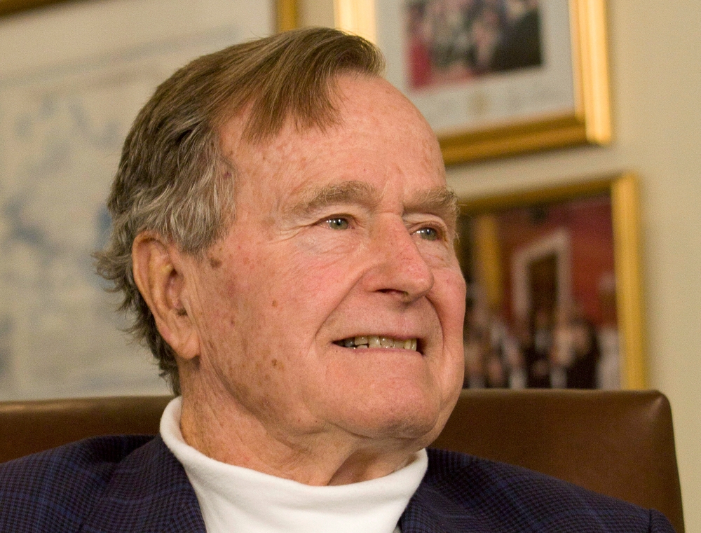 Former President George H.W. Bush smiles as he listens to Republican presidential candidate Mitt Romney speak as he met with Bush to pick up his formal endorsement in Houston, Texas, U.S. March 29, 2012. Reuters/Donna Carson