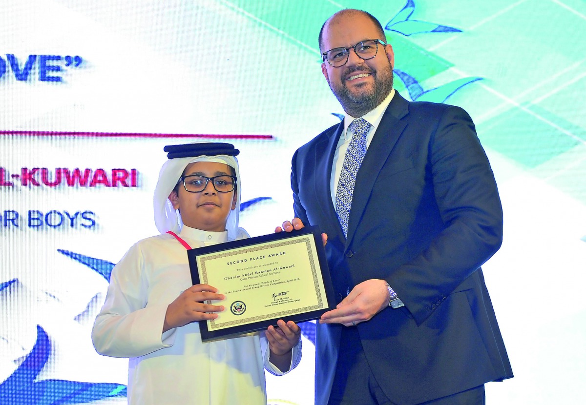 Ryan Gliha, Charge d’Affaires at the American Embassy in Qatar, awarding one of the winners during the 4th annual Young Writers Award ceremony. Pic: Baher Amin / The Peninsula
