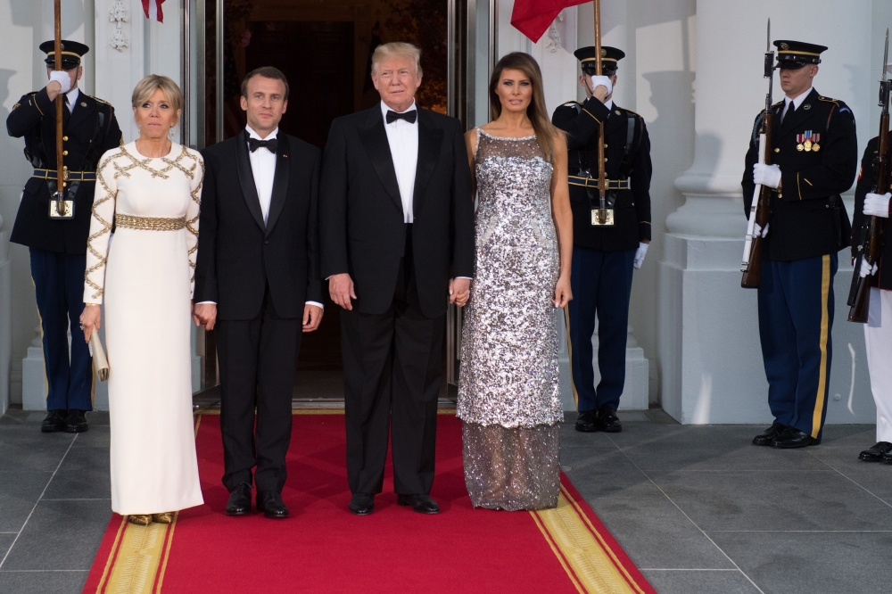 US President Donald Trump and First Lady Melania Trump welcome French President Emmanuel Macron and his wife, Brigitte Macron, as they arrive for a State Dinner at the North Portico of the White House in Washington, DC, April 24, 2018. AFP / SAUL LOEB