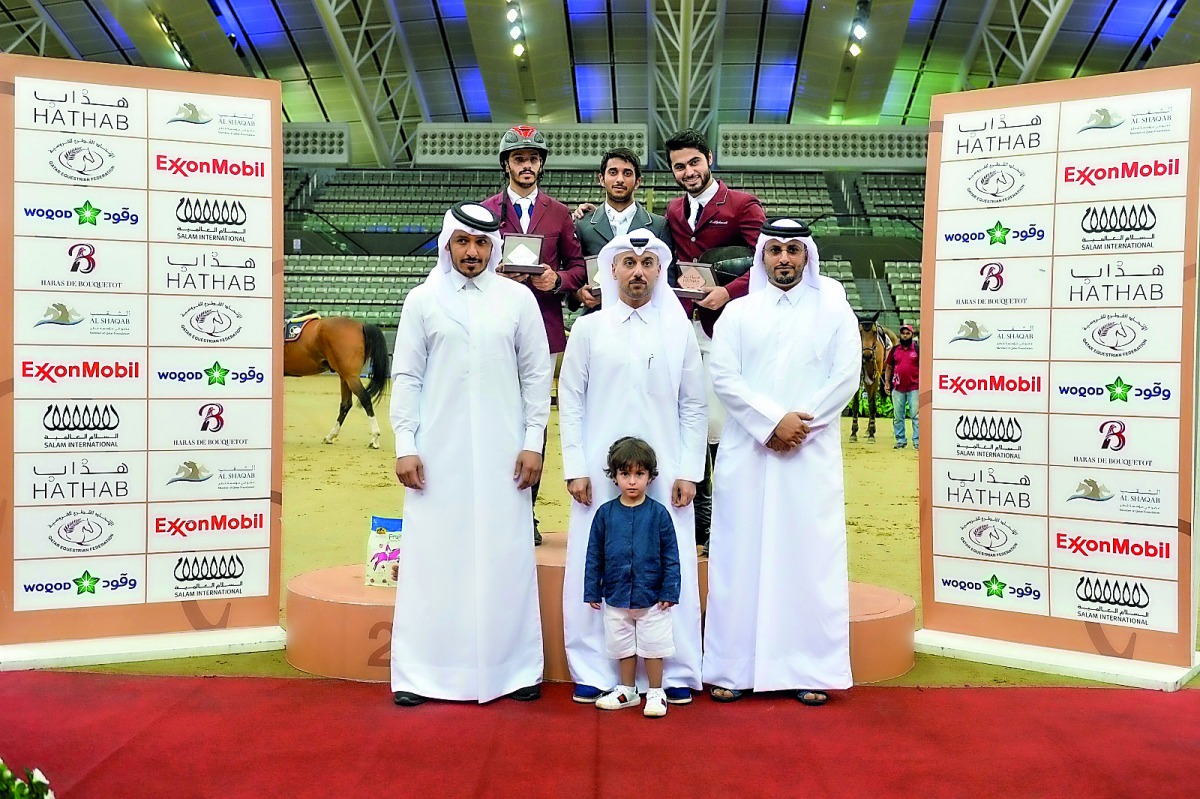 The podium winners of the Big Tour pose for a photograph with officials after the presentation ceremony at the Al Shaqab’s main arena yesterday.
