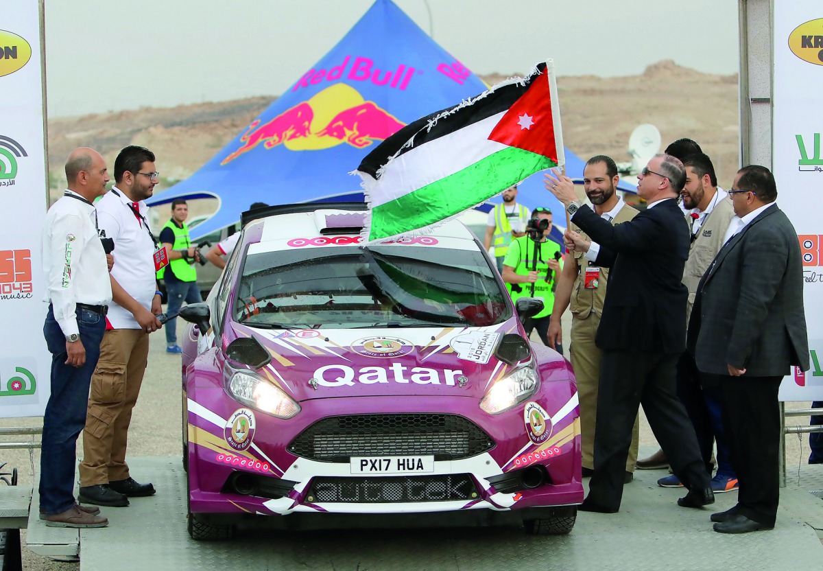 Prince Feisal Al Hussein flags Nasser Saleh Al Attiyah from the starting point  of the Jordan Rally yesterday.