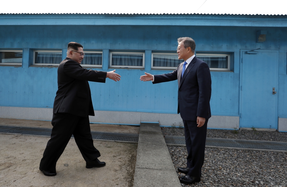 South Korean President Moon Jae-in (R) and North Korean leader Kim Jong-un (L) meet at the Military Demarcation Line of the truce village of Panmunjom, South Korea on April 27, 2018. Kim Jong-un is the first North Korean leader to enter South Korea since 