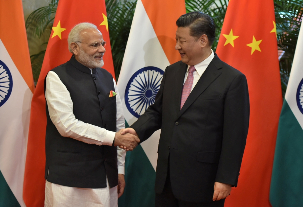 Chinese President Xi Jinping (R) shakes hands with Indian Prime Minister Narendra Modi during their visit at East Lake Guest House, in Wuhan, China, April 27, 2018. India's Press Information Bureau/Handout via Reuters