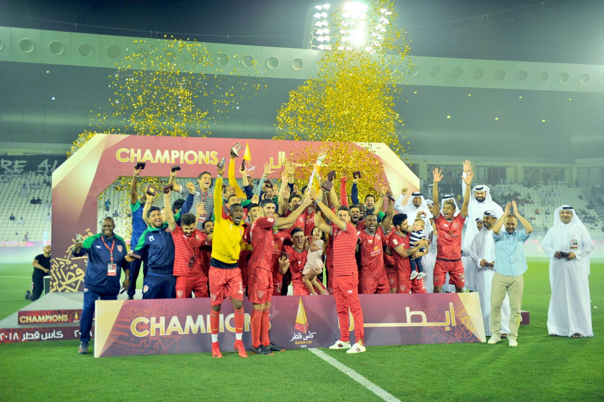 Al Duhail players and officials celebrate their win over Al Sadd in the Qatar Cup final at Al Sadd Stadium in Doha yesterday. Pic:Baher Amin/The Peninsula