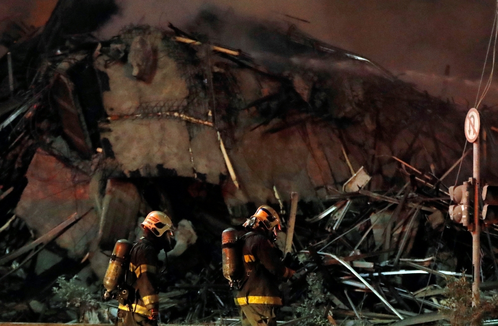 Firefighters work at the site where a building collapsed, in downtown Sao Paulo, Brazil May 1, 2018. REUTERS/Leonardo Benassatto